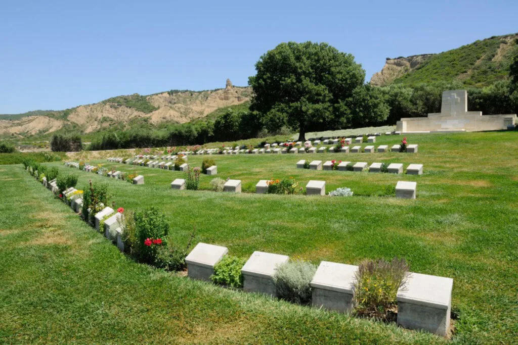 View of Beach Cemetery at Gallipoli Peninsula in Çanakkale, Turkey, with aligned gravestones and sea in the background.