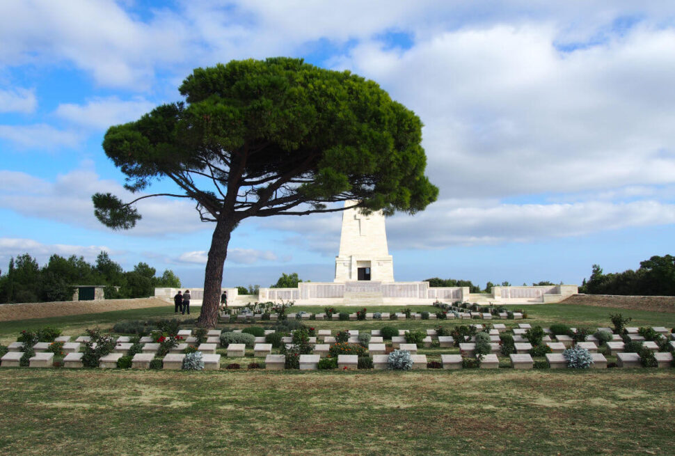 Lone Pine Cemetery and Memorial with a large pine tree and soldier graves in Gallipoli Peninsula, Çanakkale, Turkey.