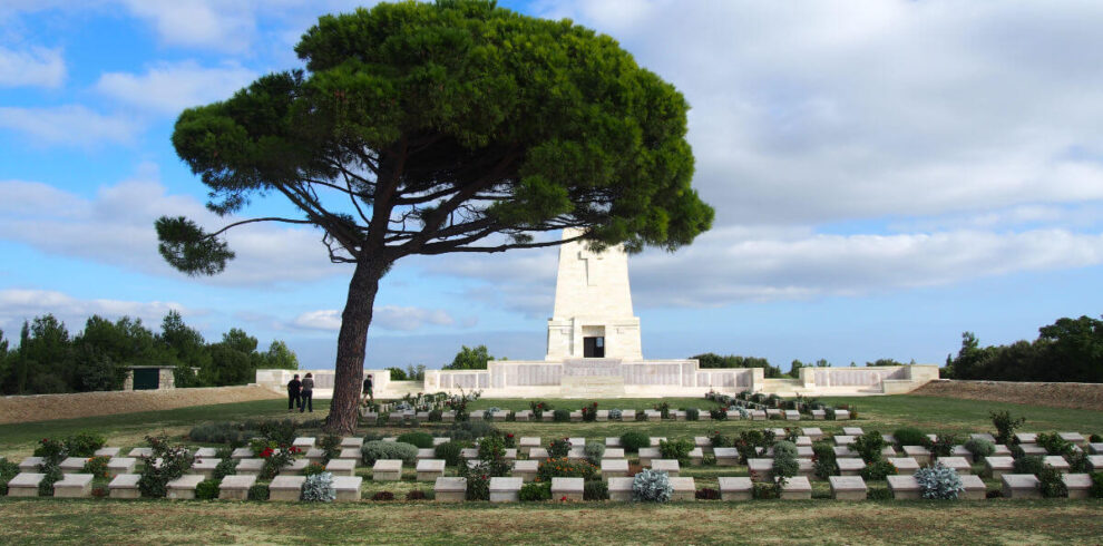 Lone Pine Cemetery and Memorial with a large pine tree and soldier graves in Gallipoli Peninsula, Çanakkale, Turkey.