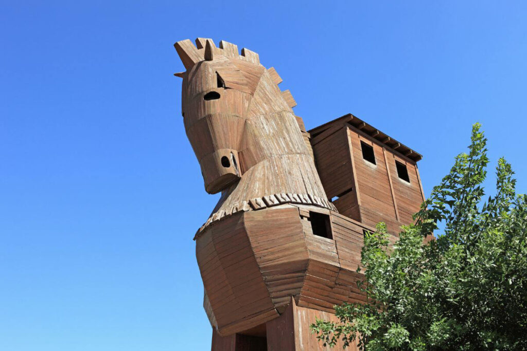 Wooden Trojan Horse replica under blue sky at the ancient city of Troy in Çanakkale, Turkey.