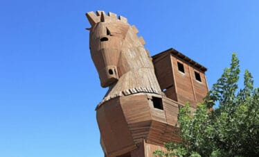 Wooden Trojan Horse replica under blue sky at the ancient city of Troy in Çanakkale, Turkey.