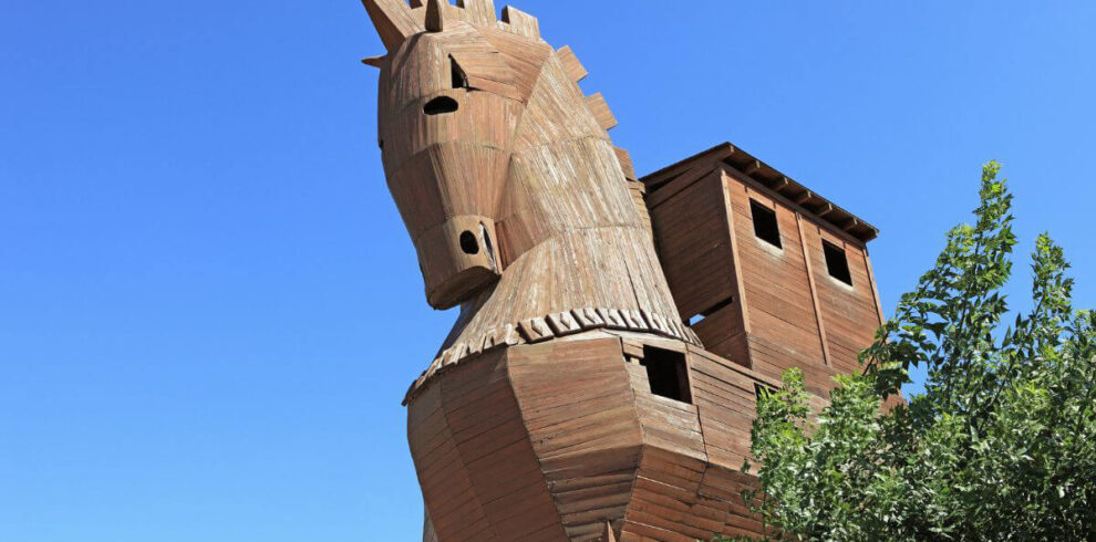Wooden Trojan Horse replica under blue sky at the ancient city of Troy in Çanakkale, Turkey.