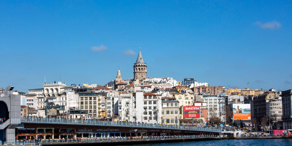 Galata Tower rising above Istanbul's skyline with the Galata Bridge spanning the Golden Horn below.