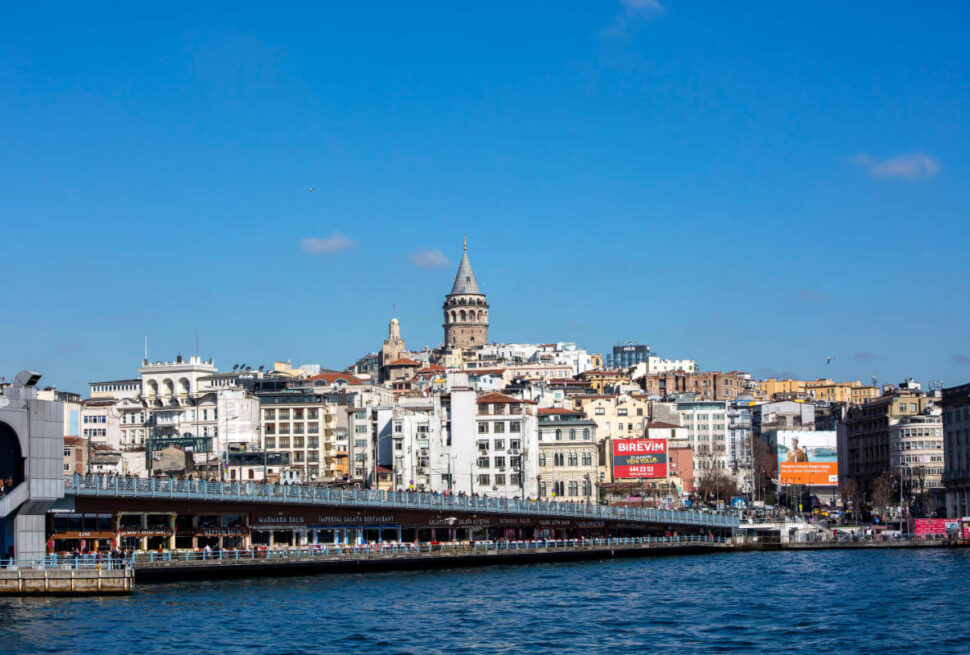 Galata Tower rising above Istanbul's skyline with the Galata Bridge spanning the Golden Horn below.