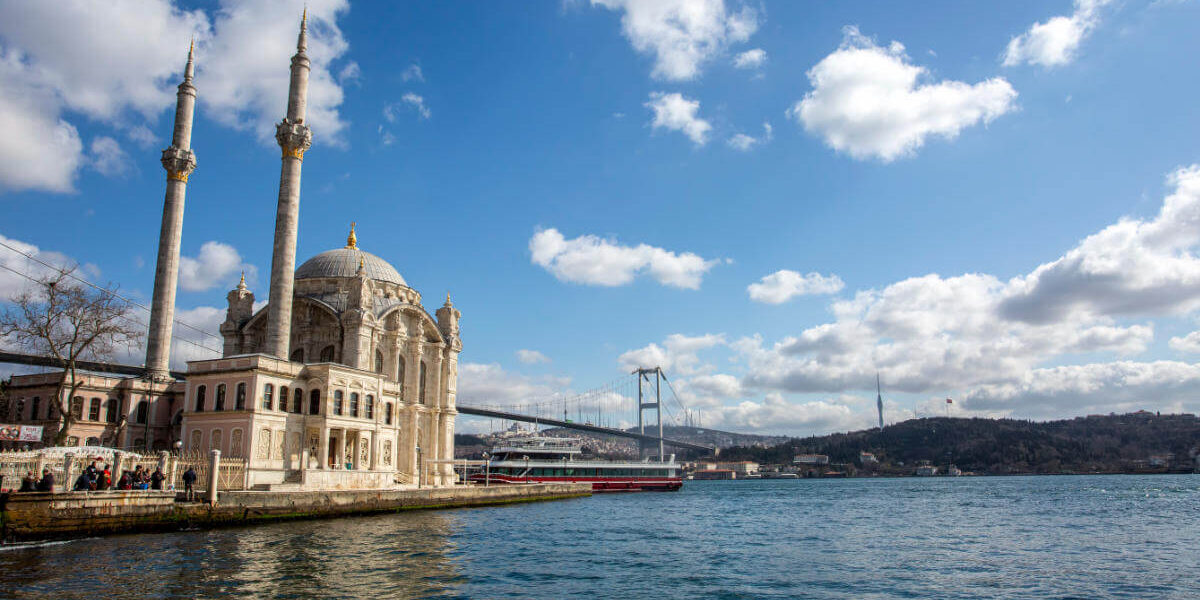 Elegant Ortaköy Mosque with twin minarets beside the Bosphorus and Bosphorus Bridge in Istanbul, Turkey