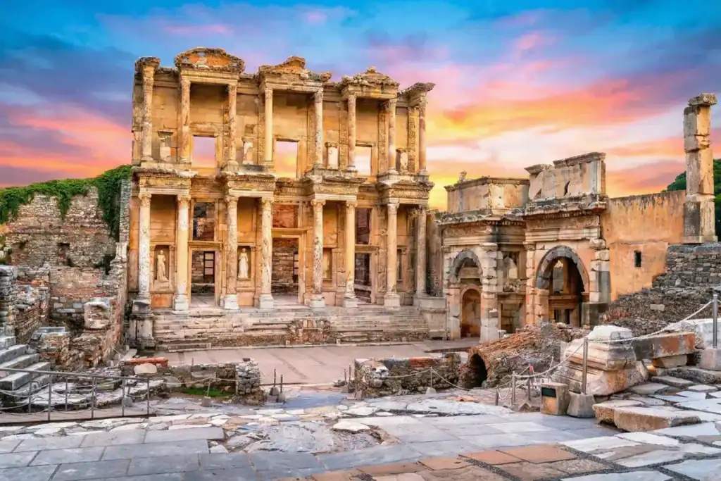 Magnificent facade of the Celsus Library in Ephesus Ancient City, Izmir, Turkey, under a bright and clear sunset sky.