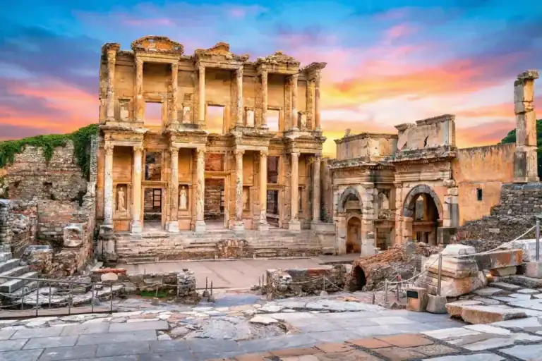 Magnificent facade of the Celsus Library in Ephesus Ancient City, Izmir, Turkey, under a bright and clear sunset sky.