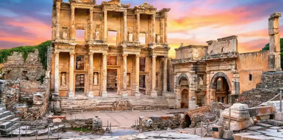 Magnificent facade of the Celsus Library in Ephesus Ancient City, Izmir, Turkey, under a bright and clear sunset sky.