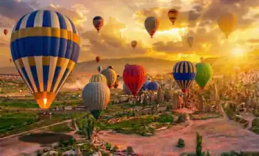 Colorful hot air balloons at sunrise in Cappadocia Turkey - Best of Istanbul and Cappadocia tours by One Nation Travel