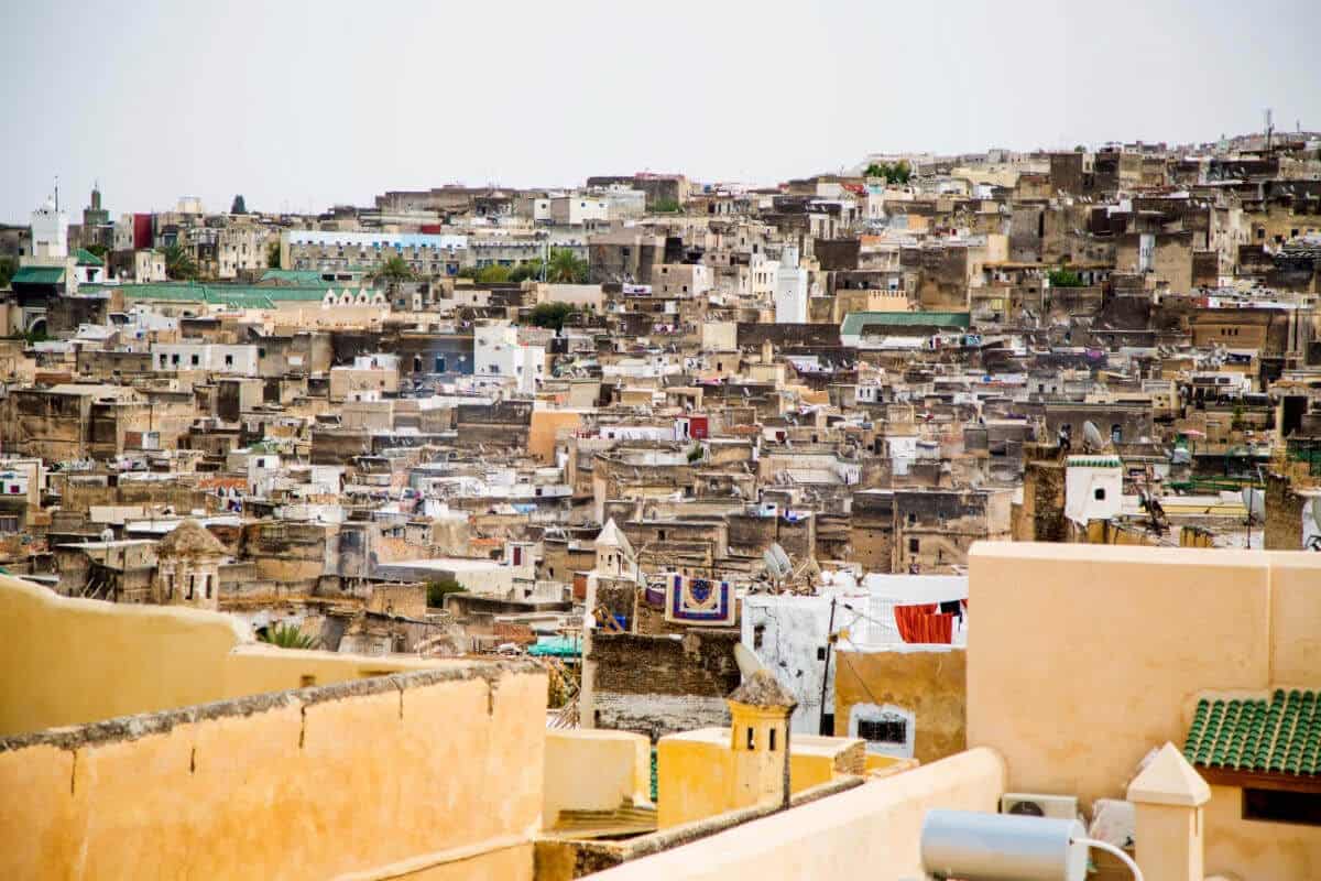 Densely packed rooftops and buildings of the historic Medina of Fez, Morocco with traditional architecture.
