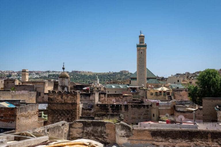 Morocco Weather in May: Temperatures & Travel Tips 1 Panoramic view of Fes el Bali with Al-Qarawiyyin Mosque minaret in Fes, Morocco under clear blue sky.
