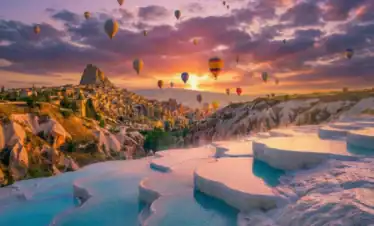 Sunrise view featuring hot air balloons in Cappadocia and white travertines of Pamukkale for the 3 Days Cappadocia and Pamukkale Tour from Istanbul.