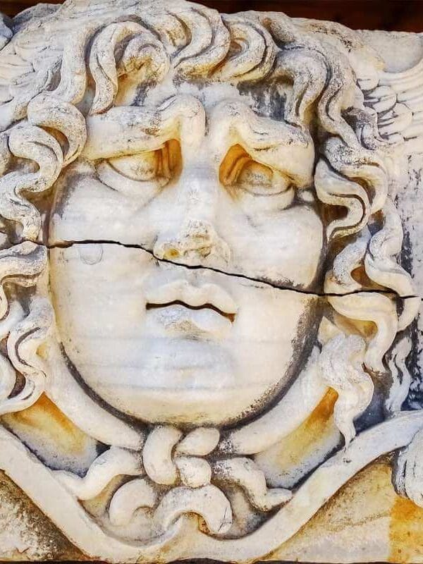Medusa head relief at Didyma Ancient City, Aydın, with wavy hair and intricate Greco-Roman stone craftsmanship.