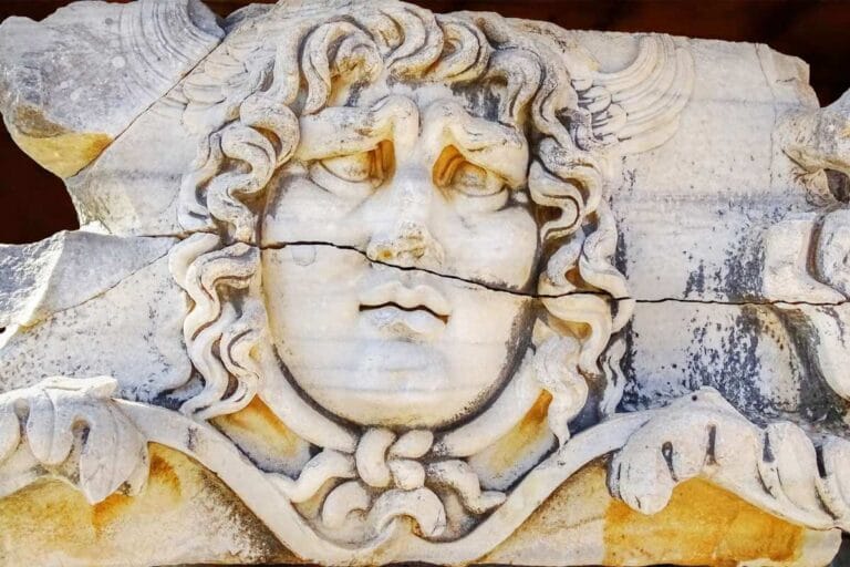 Medusa head relief at Didyma Ancient City, Aydın, with wavy hair and intricate Greco-Roman stone craftsmanship.