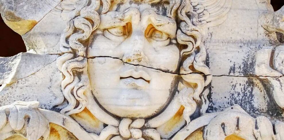 Medusa head relief at Didyma Ancient City, Aydın, with wavy hair and intricate Greco-Roman stone craftsmanship.