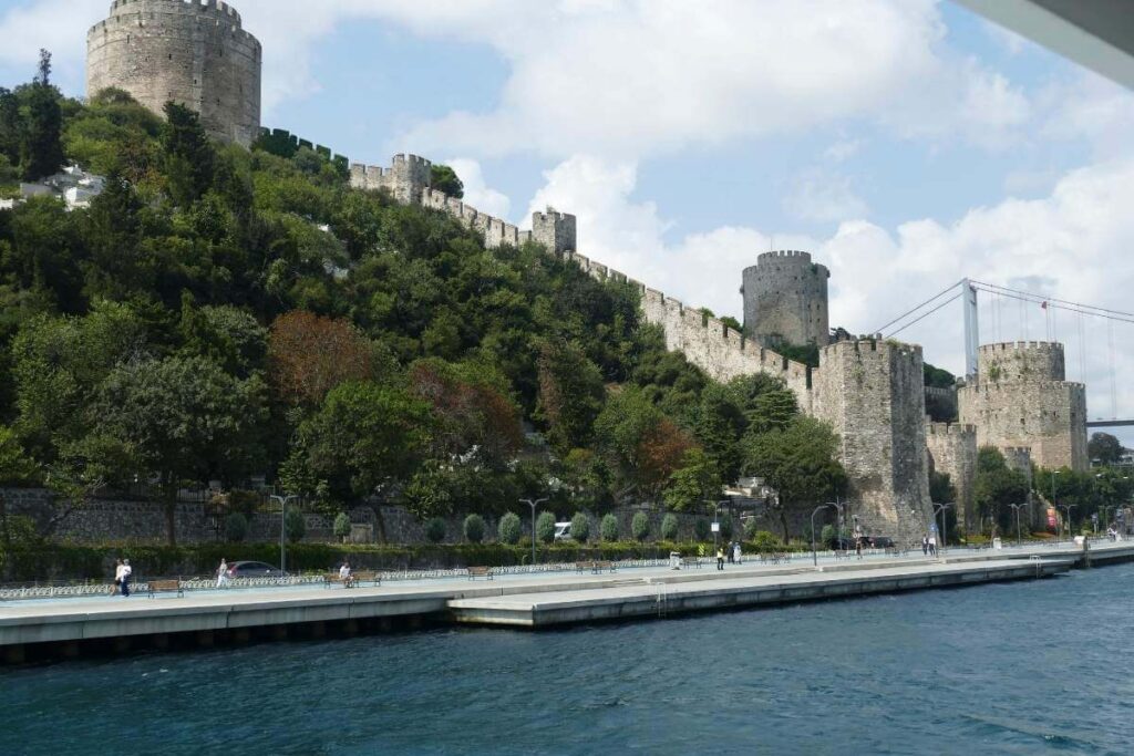 Rumeli Fortress with stone towers and walls on the Bosphorus shoreline in Istanbul.
