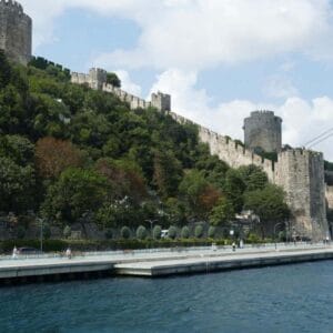 Rumeli Fortress with stone towers and walls on the Bosphorus shoreline in Istanbul.