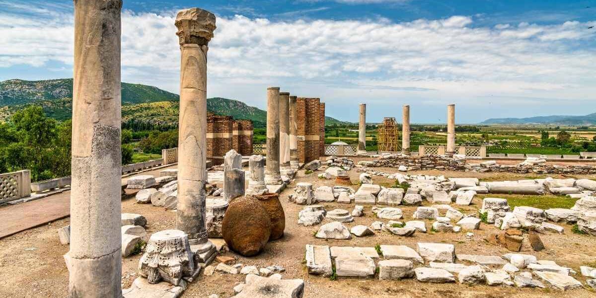Ancient ruins of stone columns and scattered marble remains at the Basilica of St. John in Selçuk, Turkey.