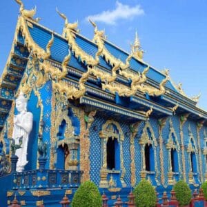 Wat Rong Suea Ten Blue Temple in Chiang Rai with golden carvings, vivid blue walls, and ornate Buddhist architecture.