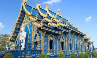Wat Rong Suea Ten Blue Temple in Chiang Rai with golden carvings, vivid blue walls, and ornate Buddhist architecture.