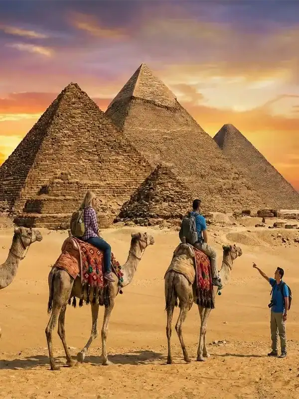Travelers enjoying Egypt tours from USA with a guided sunset camel ride at the Great Pyramids of Giza.
