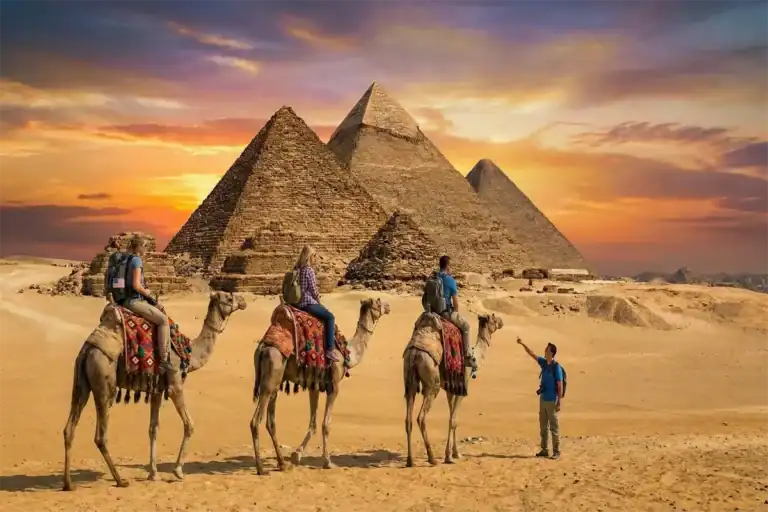 How Many Days Are Enough to See Egypt? - Expert Guide 1 Travelers enjoying Egypt tours from USA with a guided sunset camel ride at the Great Pyramids of Giza.