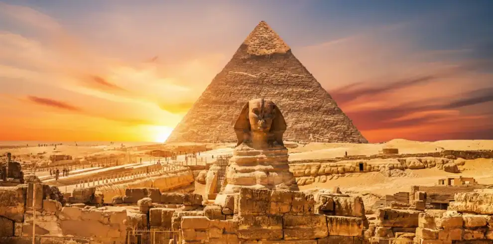 A cinematic and vibrant view of the Great Pyramid of Giza and the Sphinx in Egypt, featuring a surreal cosmic sunset with a starry galaxy sky and purple nebulae.