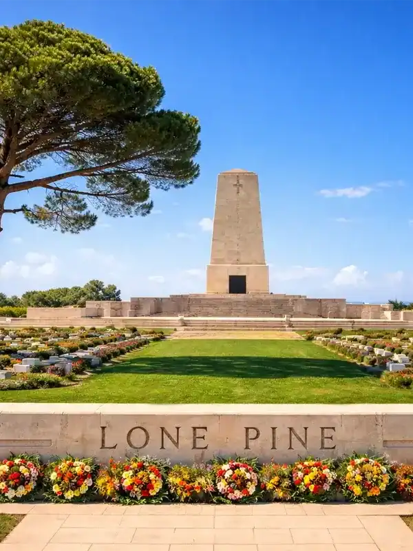 Lone Pine Australian Memorial in Gallipoli, Turkey with ANZAC battlefield cemetery, obelisk monument and lone pine tree under blue sky.