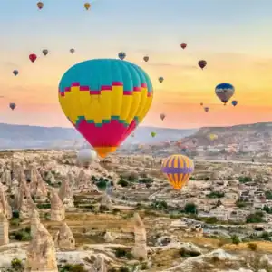 Hot Air Balloons flying over valleys during One Nation Travel Cappadocia Tours