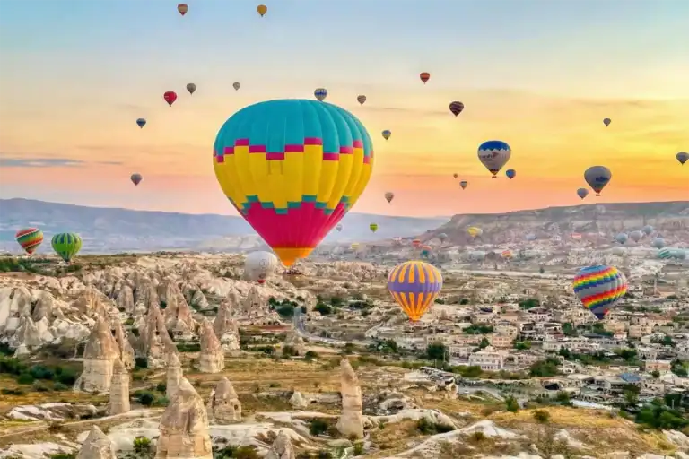 Hot Air Balloons flying over valleys during One Nation Travel Cappadocia Tours