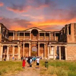 A vibrant sunset view of the monumental Roman Gymnasium at the Sardis Ancient City, a key stop on the Seven Churches of Revelation Tour in Turkey.