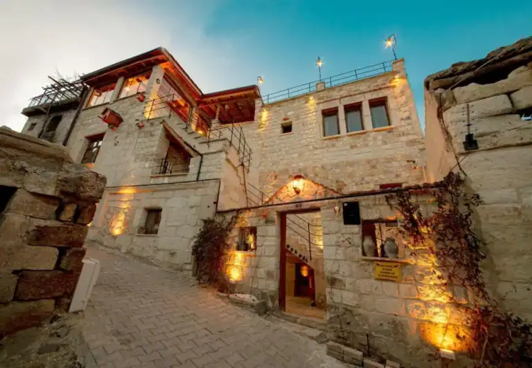 Cappadocia Weather in December: What to Expect & Travel Tips 3 Zula Cave House with traditional Cappadocia stone architecture, warm exterior lighting, and charming historic street entrance.
