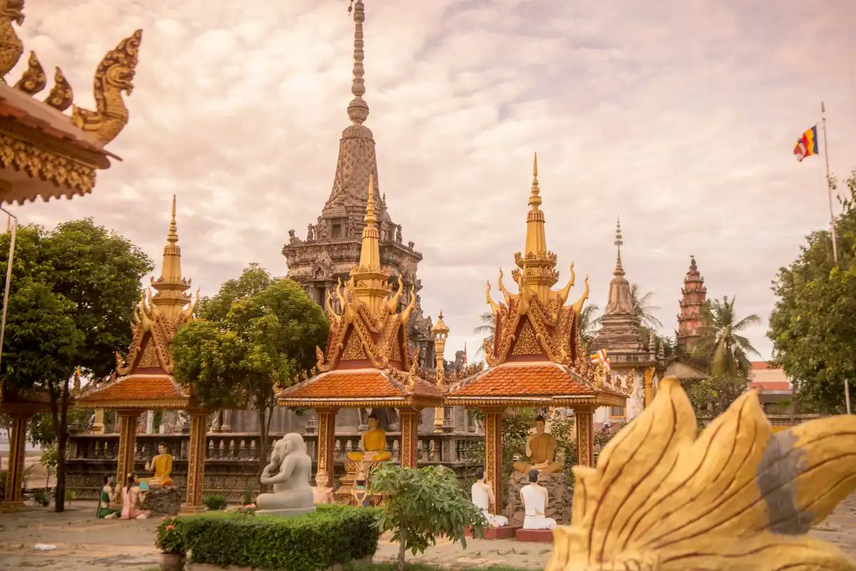 Wat Kampong temple in Kampong Thom, Cambodia, featuring ornate Khmer architecture, Buddha statues, and decorative stupas.
